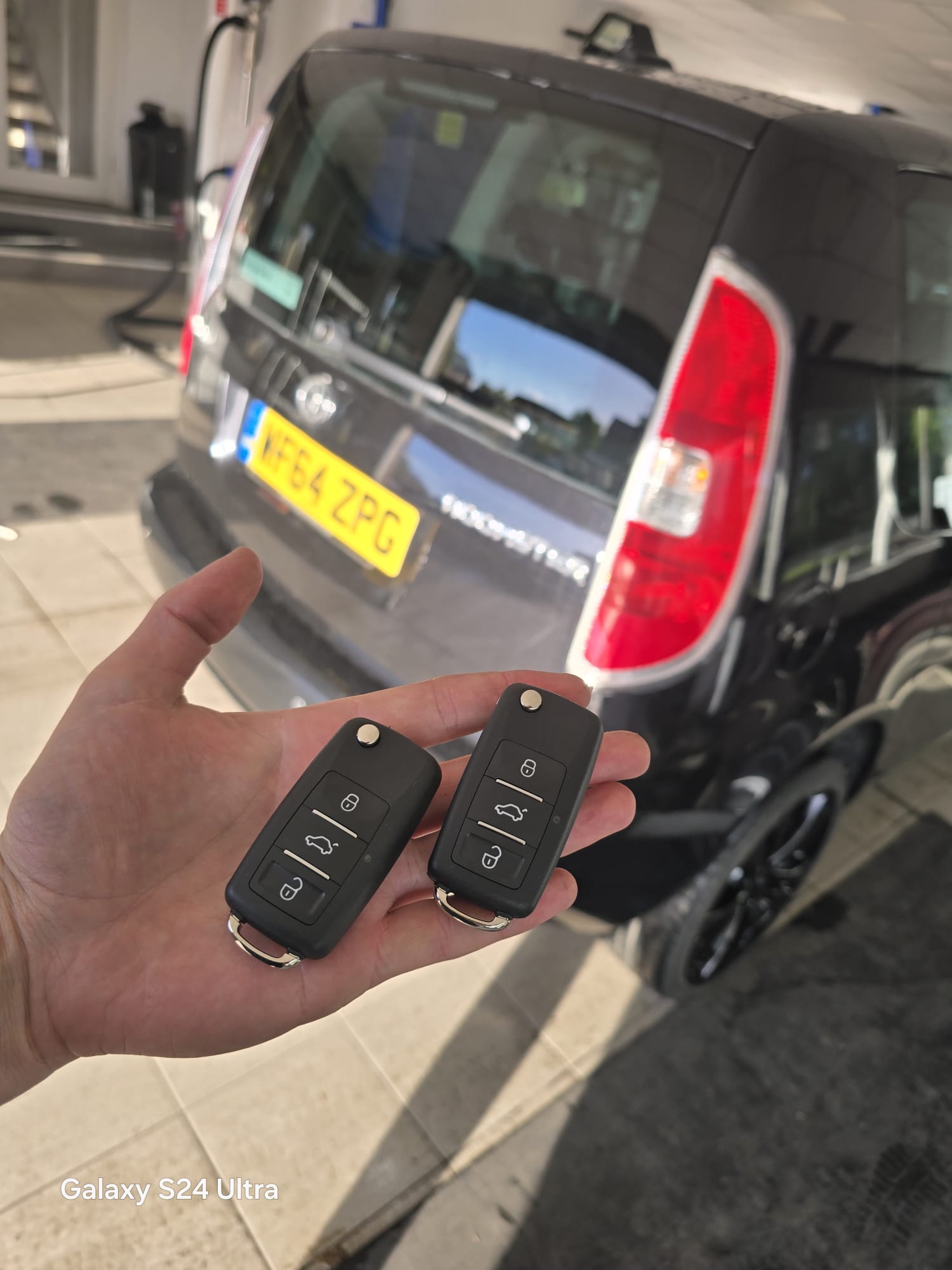 Two flip keys programmed for a black VW Transporter van at a driveway callout