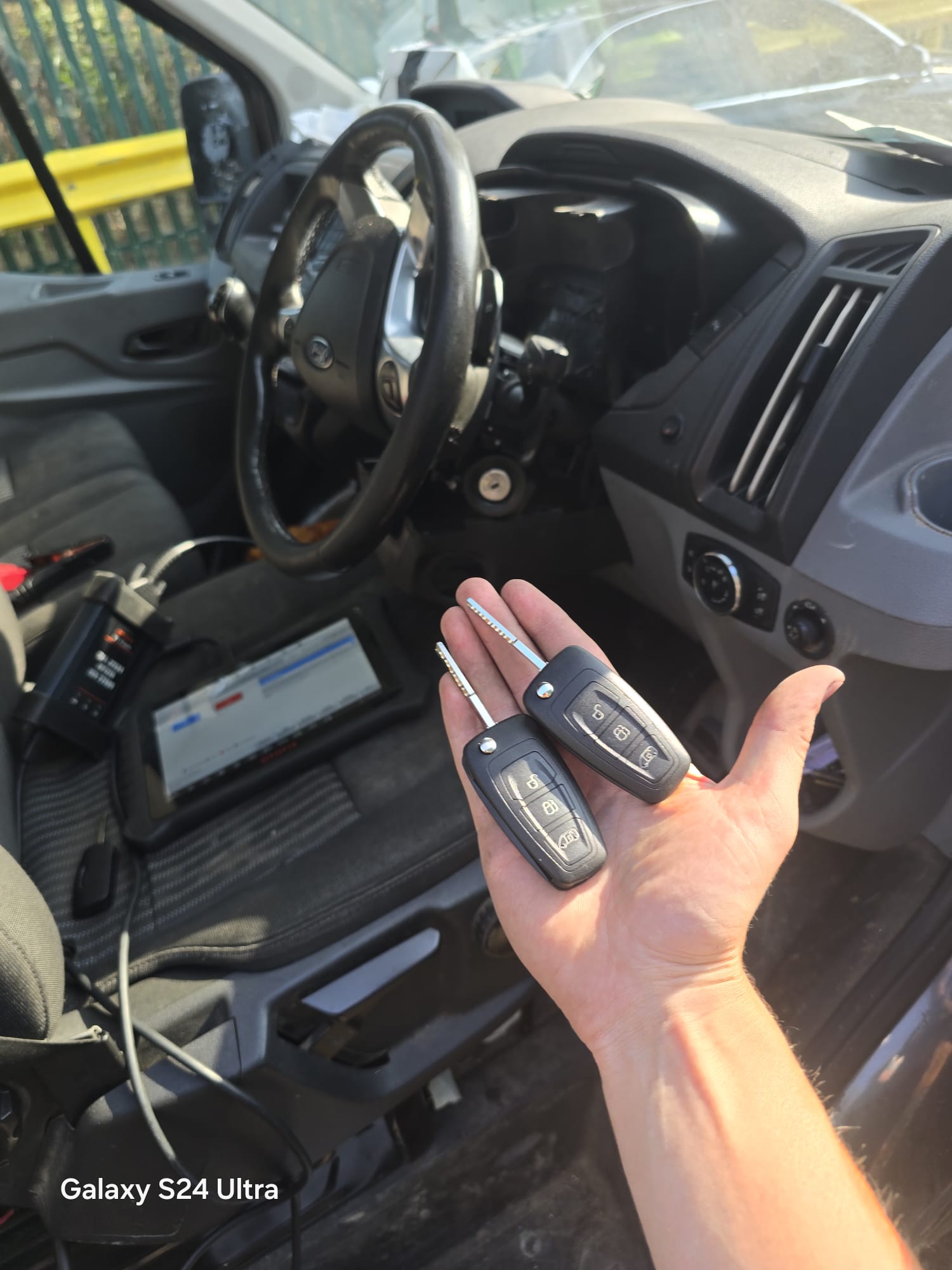 Two replacement Ford Transit flip keys cut and programmed with diagnostic equipment connected in the cab