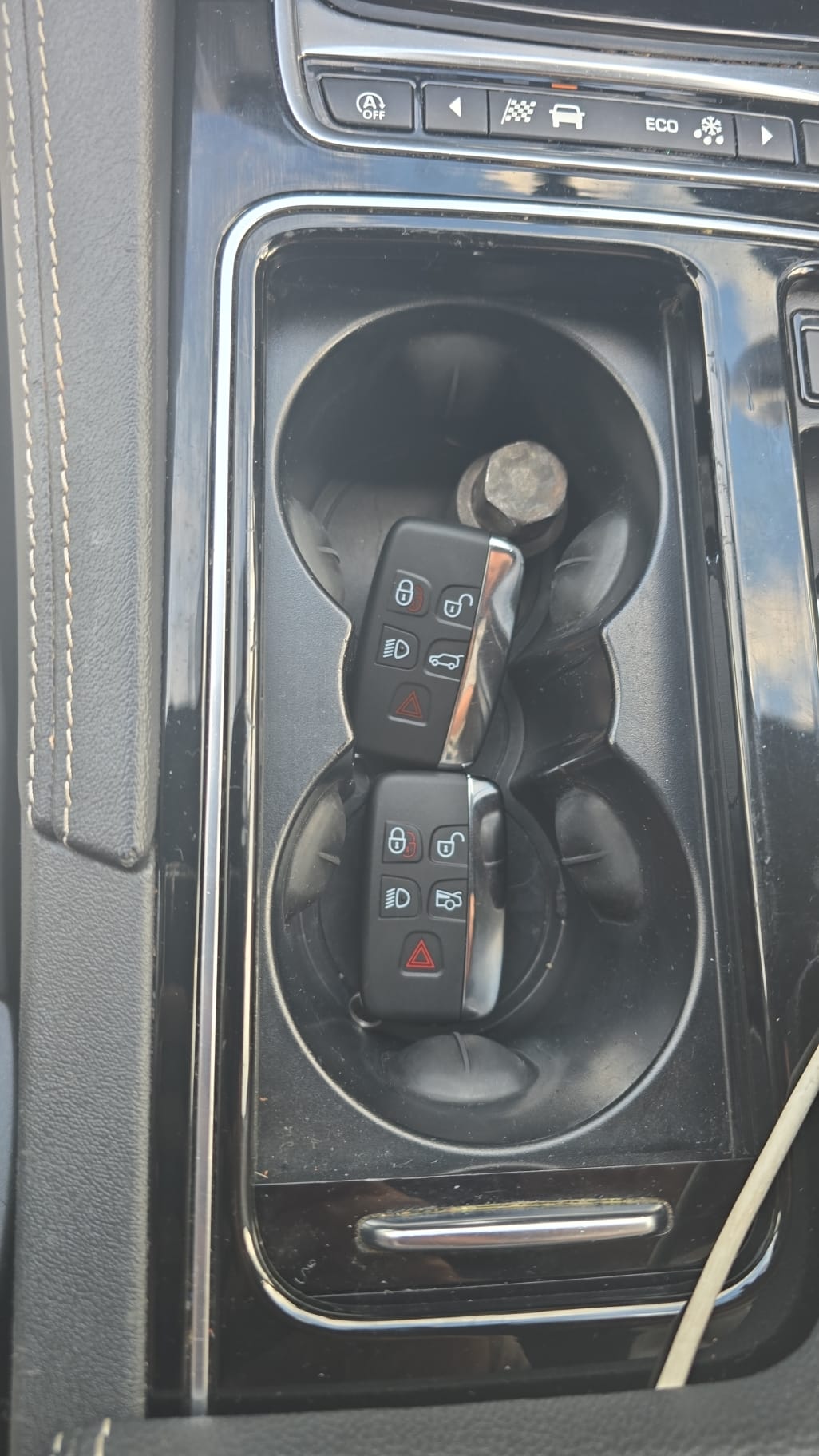 Two Jaguar XF smart keys in the cup holder after a second key was added