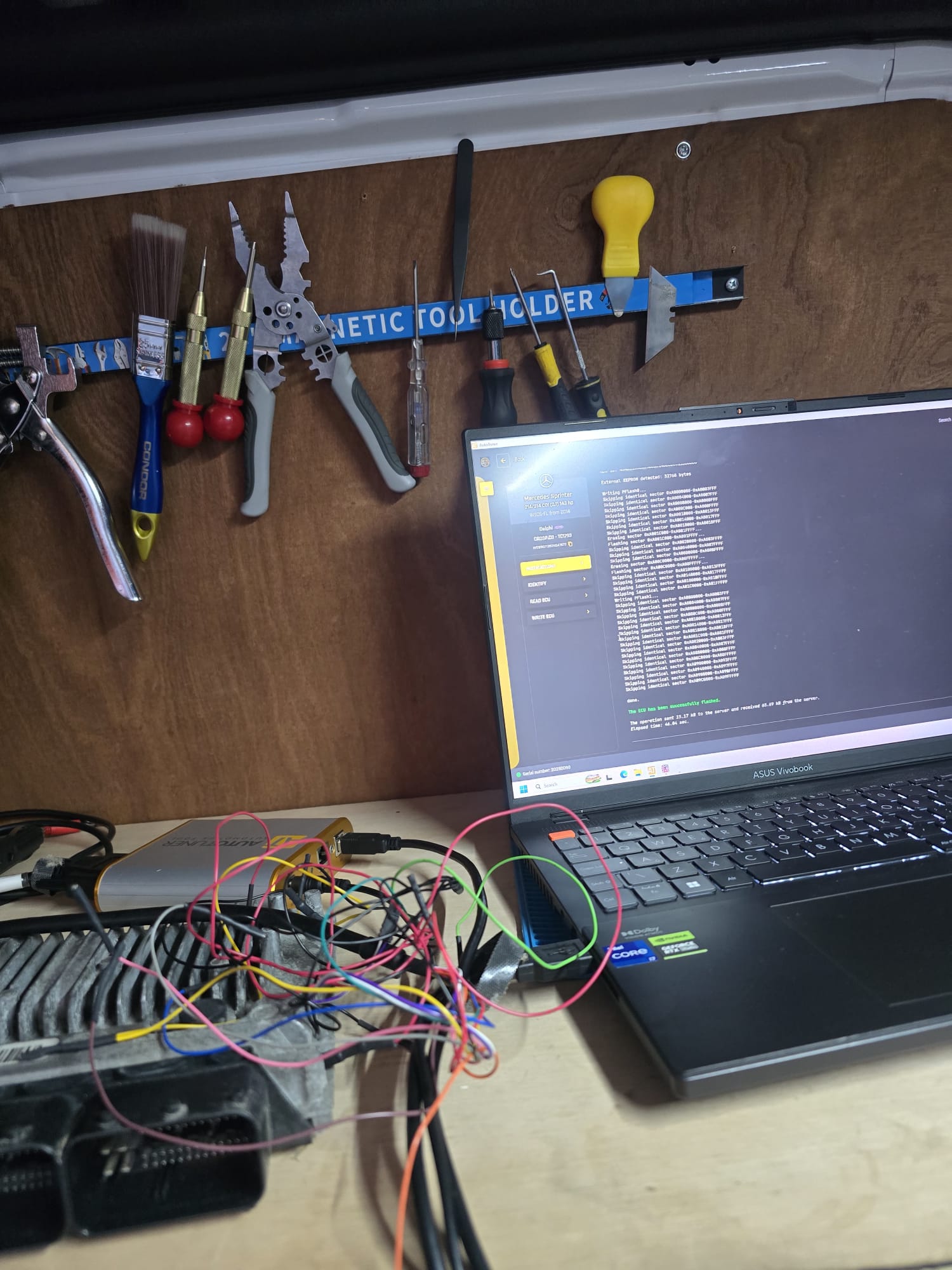 Mercedes Sprinter ECU programming on a workshop bench with laptop and specialist automotive tools