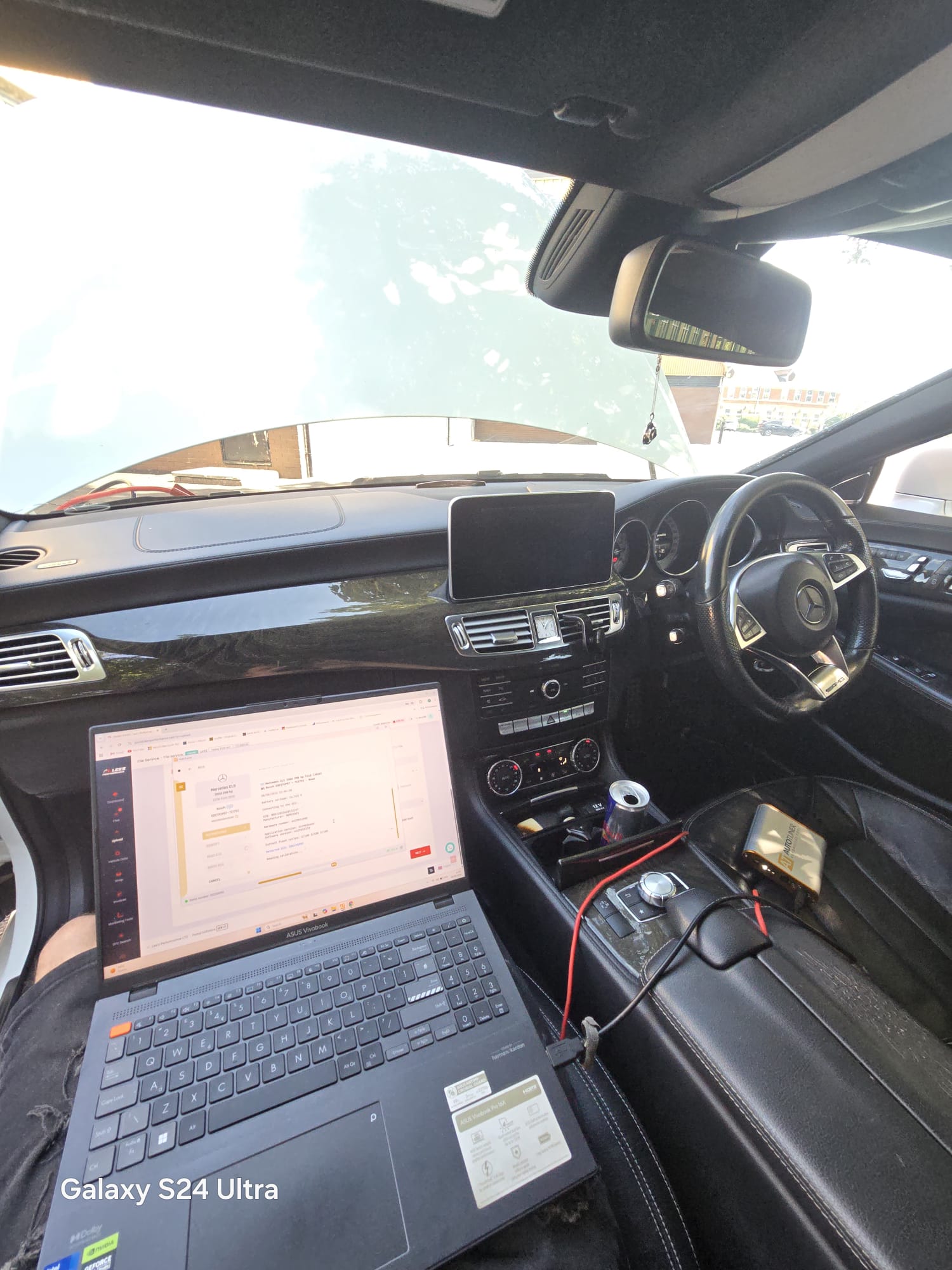 Mercedes CLS AMG interior with laptop showing the ECU file service and AutoTuner connected on the centre console