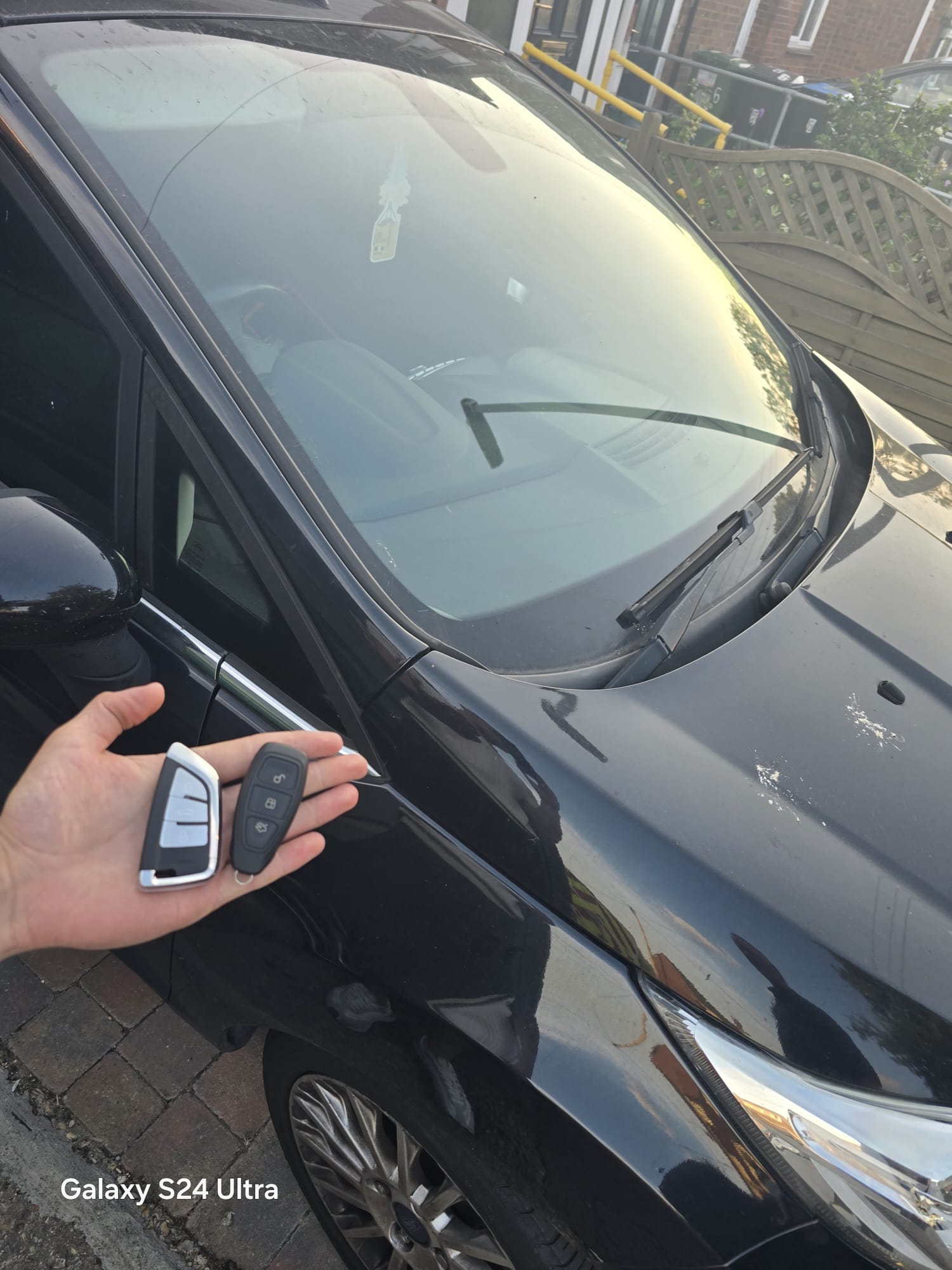 Ford proximity smart key programmed on a black Ford at a residential driveway