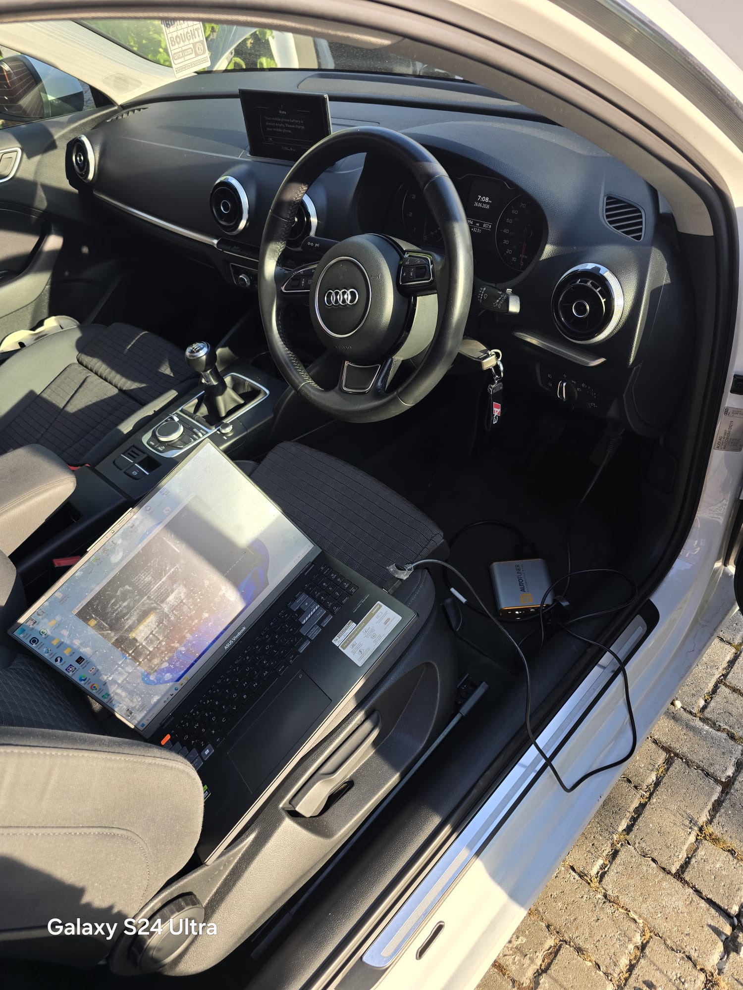 Mobile ECU coding session for a white Audi A3 with laptop and AutoTuner tool