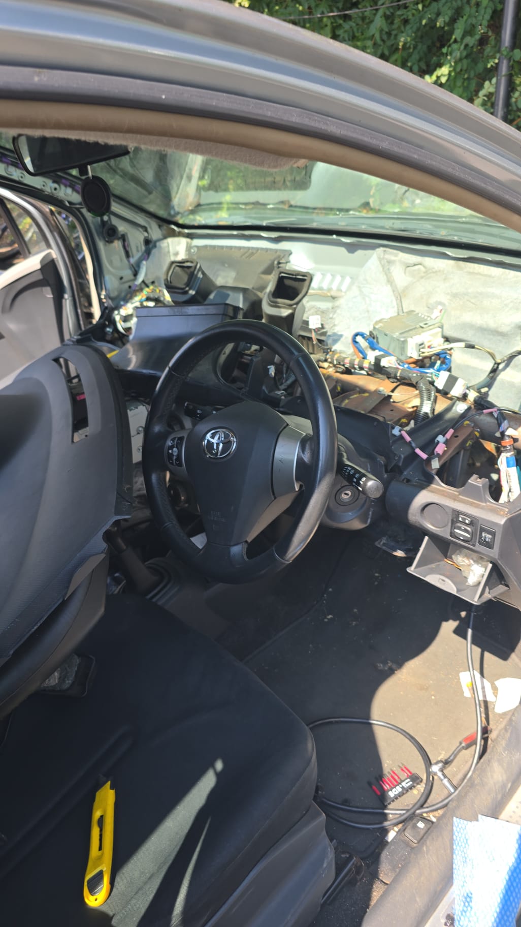 Toyota iQ dashboard stripped down exposing wiring during a theft-recovery rewire and key programming job