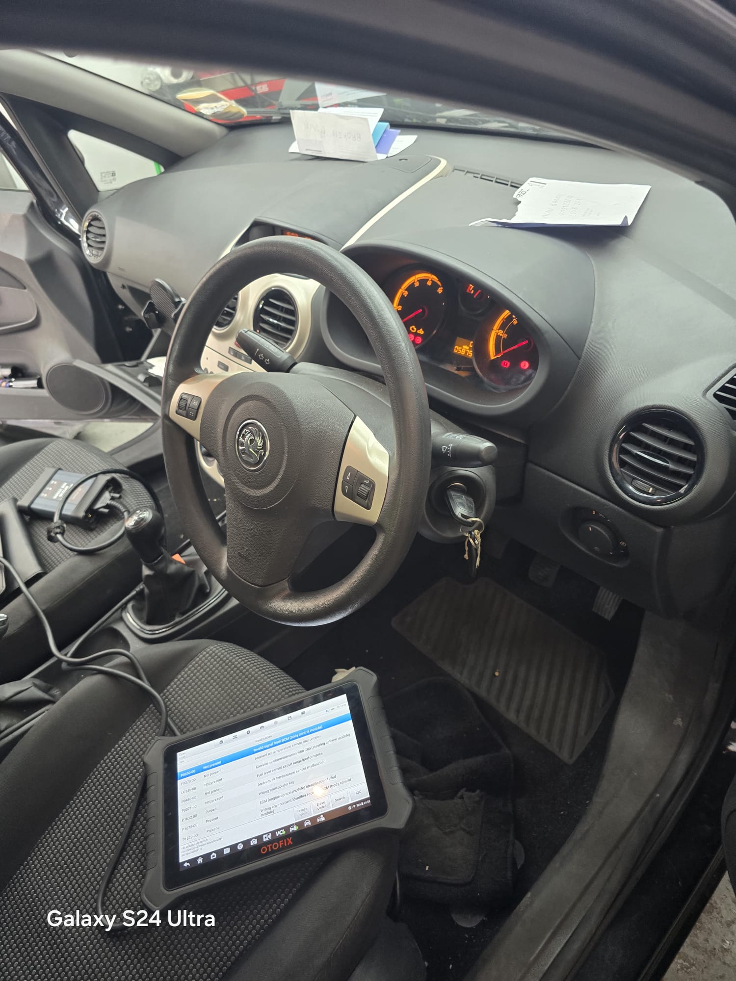 Vauxhall Corsa dashboard with OtoFix diagnostic tablet showing BCM fault codes during key programming