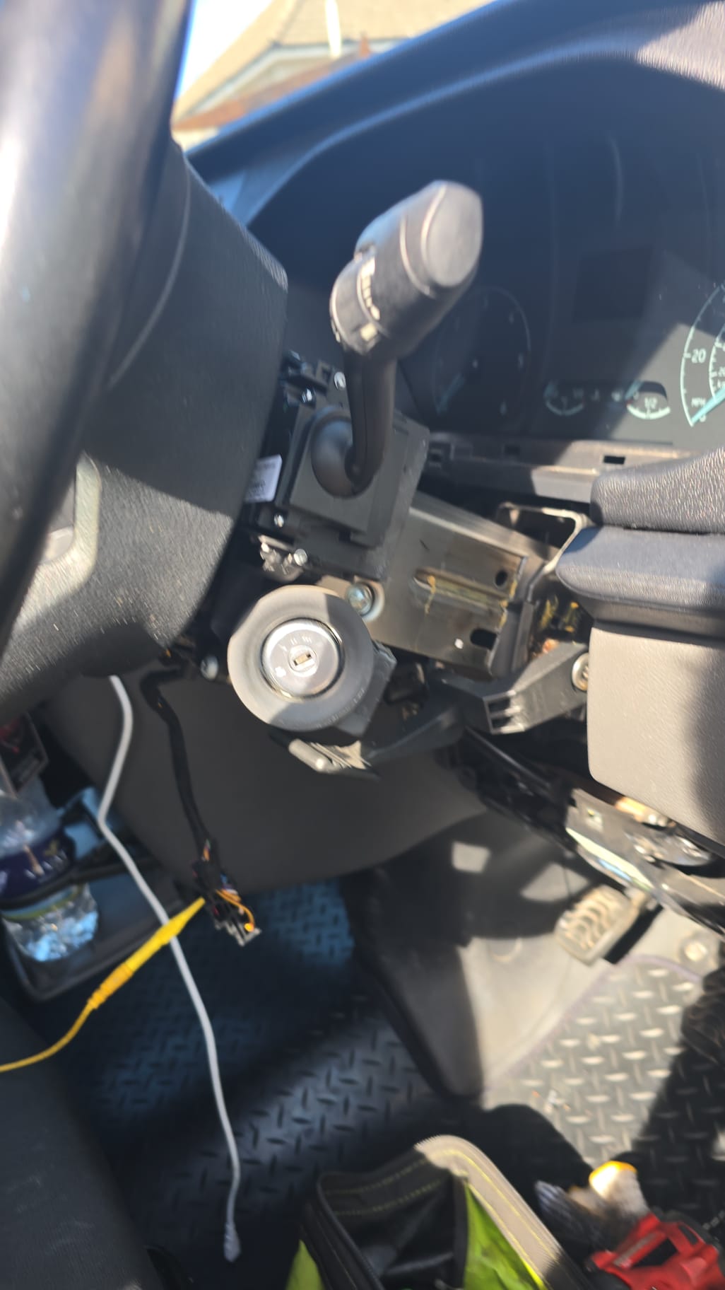 Steering column stripped down exposing the ignition barrel during a mobile ignition lock repair