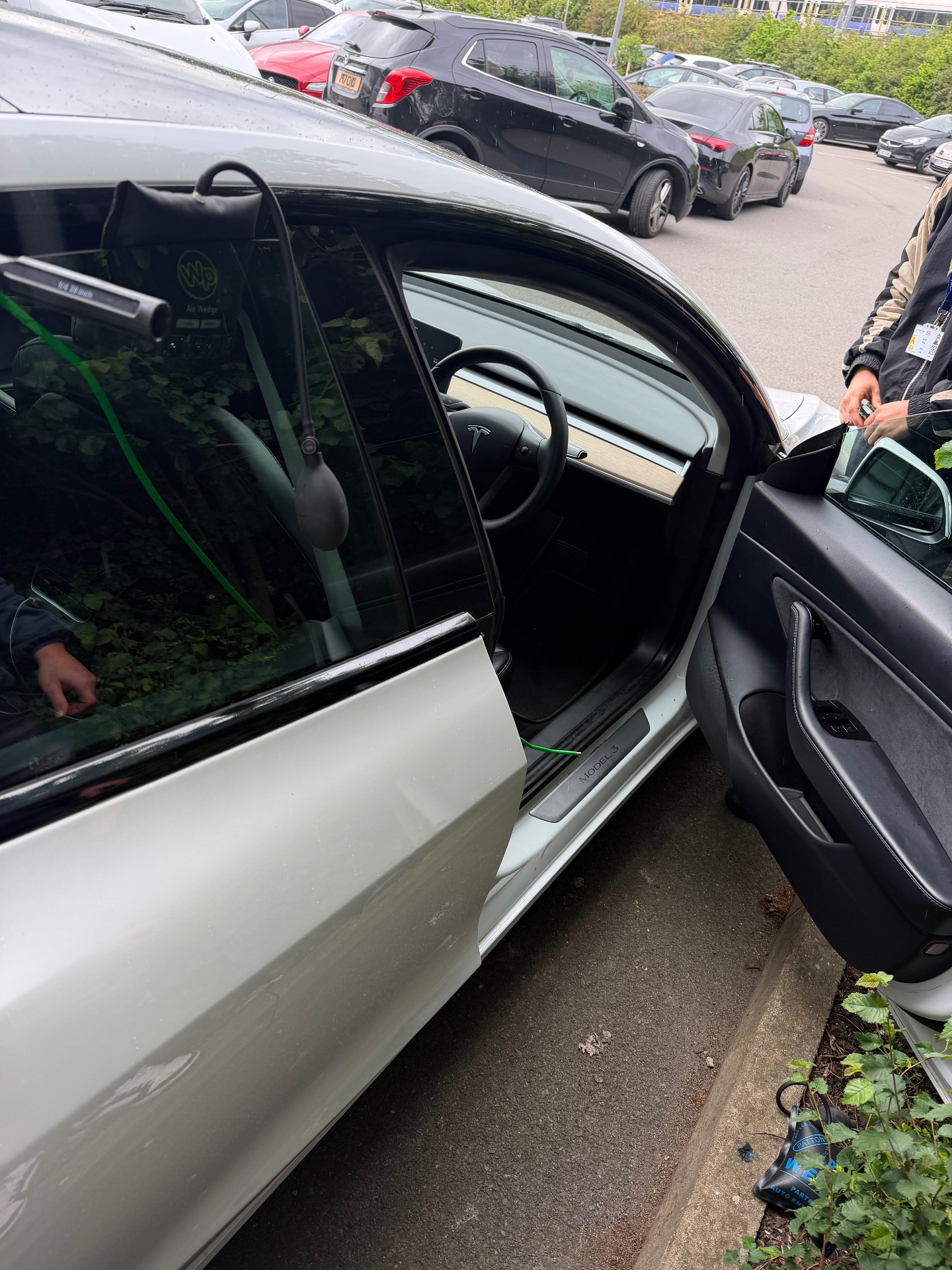 Professional damage-free car unlock service in West London — non-destructive entry on a red saloon