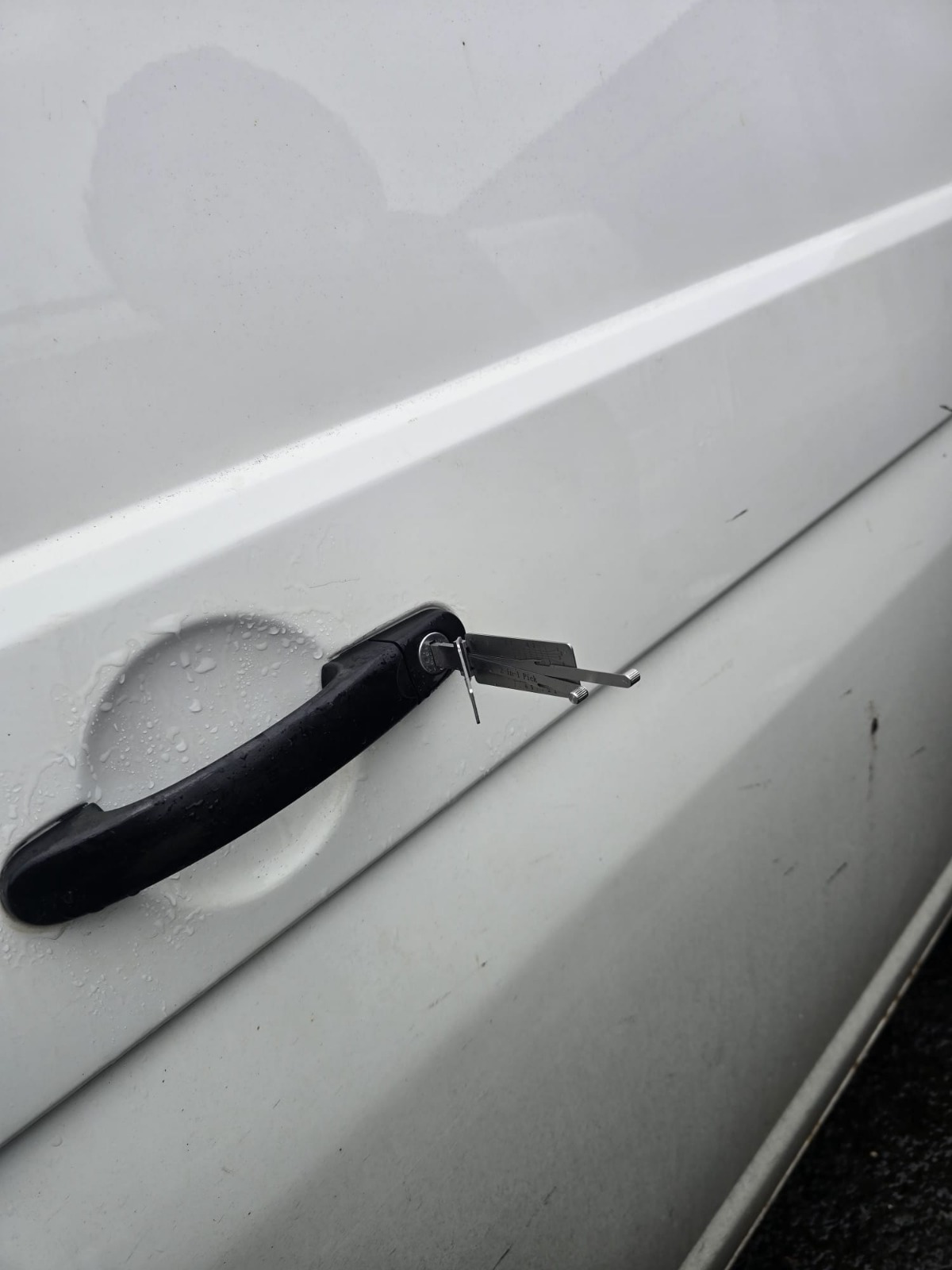 Damage-free door unlock on a white car using professional 2-in-1 pick
