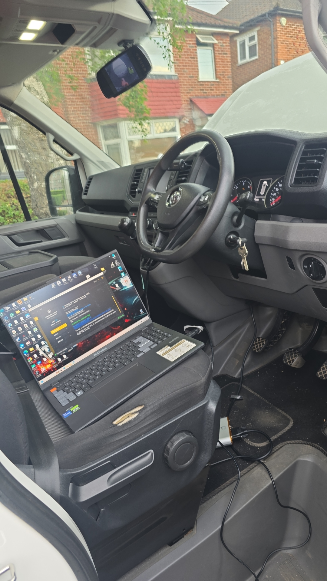 VW Crafter van mobile ECU remap with diagnostic laptop on the driver's seat in West London